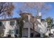 Charming two-story exterior with a private entrance, balcony, and mature trees at 5206 Mandalay Springs Dr # 204, Las Vegas, NV 89120