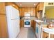 Well-lit kitchen with stainless appliances, stone countertops, tile backsplash, and ample wooden cabinetry at 5206 Mandalay Springs Dr # 204, Las Vegas, NV 89120