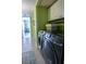 Laundry room with a tile floor, and modern washer and dryer next to storage cabinets at 5206 Mandalay Springs Dr # 204, Las Vegas, NV 89120