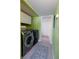 Bright laundry room with modern washer and dryer, and convenient overhead storage cabinets at 5206 Mandalay Springs Dr # 204, Las Vegas, NV 89120