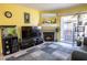 Inviting living room with a cozy fireplace, neutral-toned walls, and an outdoor patio at 5206 Mandalay Springs Dr # 204, Las Vegas, NV 89120