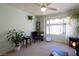 Bright living room featuring a ceiling fan and lots of plants by a sunny window at 5206 Mandalay Springs Dr # 204, Las Vegas, NV 89120