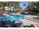 Community swimming pool surrounded by lounge chairs and lush landscaping, perfect for relaxation at 5206 Mandalay Springs Dr # 204, Las Vegas, NV 89120