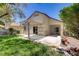 Backyard featuring a covered patio, lush green lawn, mature landscaping, and a pergola offering shade and relaxation at 5240 Adorato Dr, North Las Vegas, NV 89031