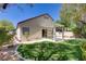 Inviting backyard with a pergola-covered patio, lush lawn, and mature landscaping at 5240 Adorato Dr, North Las Vegas, NV 89031