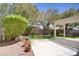 Spacious backyard featuring a concrete patio, pergola, lush landscaping, mature trees, and privacy fencing at 5240 Adorato Dr, North Las Vegas, NV 89031