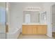 Bathroom featuring double sinks, a bathtub, and a shower at 5240 Adorato Dr, North Las Vegas, NV 89031