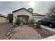 Charming single-story home featuring desert landscaping and a covered front porch, complemented by an attached two-car garage at 5240 Adorato Dr, North Las Vegas, NV 89031