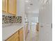 Well-lit kitchen with stylish backsplash, light wood cabinets, and modern appliances for cooking convenience at 5240 Adorato Dr, North Las Vegas, NV 89031