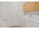 Laundry room with washer, dryer, and storage cabinets at 5240 Adorato Dr, North Las Vegas, NV 89031