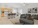 Open-concept kitchen and living space with modern finishes, plus breakfast bar seating at 5240 Adorato Dr, North Las Vegas, NV 89031