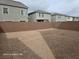 Expansive, undeveloped backyard enclosed by a brick wall, offering potential for landscaping at 5748 Avondale Rise Way, Las Vegas, NV 89141