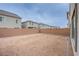 View of a spacious backyard with a brick perimeter fence, offering privacy and potential for outdoor activities at 5748 Avondale Rise Way, Las Vegas, NV 89141