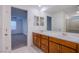Bathroom with double sink vanity, large mirror, and a view to the bedroom and shower at 5748 Avondale Rise Way, Las Vegas, NV 89141