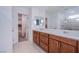 Bathroom features double sink vanity, large mirror, and view to a walk-in closet at 5748 Avondale Rise Way, Las Vegas, NV 89141
