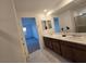 Bathroom featuring double vanity, wood cabinets, and a separate glass-enclosed shower with tile surround at 5748 Avondale Rise Way, Las Vegas, NV 89141