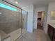 Contemporary bathroom with a glass shower and a peek at a walk-in closet nearby at 5748 Avondale Rise Way, Las Vegas, NV 89141