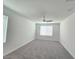 Large bedroom with neutral walls, carpet floors, a ceiling fan, and large windows at 5748 Avondale Rise Way, Las Vegas, NV 89141