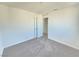 Well-lit bedroom with neutral walls, carpet floors, and a door leading to the bathroom at 5748 Avondale Rise Way, Las Vegas, NV 89141