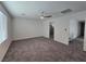 A carpeted bedroom offers ample space, enhanced by neutral walls and modern ceiling fan at 5748 Avondale Rise Way, Las Vegas, NV 89141