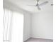 Bright bedroom with a ceiling fan, carpet floors, neutral paint and a bright window at 5748 Avondale Rise Way, Las Vegas, NV 89141