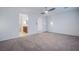 Spacious carpeted bedroom with ceiling fan and walk through to ensuite bathroom at 5748 Avondale Rise Way, Las Vegas, NV 89141