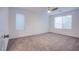 Bright bedroom with neutral carpet, ceiling fan and two sunlit windows at 5748 Avondale Rise Way, Las Vegas, NV 89141