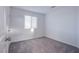 Bedroom with neutral carpet, a window, and a door to the hallway at 5748 Avondale Rise Way, Las Vegas, NV 89141