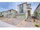 Contemporary two-story home features a two-car garage, desert landscaping, and a second-floor balcony at 5748 Avondale Rise Way, Las Vegas, NV 89141