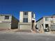 A modern two-story home featuring a balcony and a two-car garage, set against a clear blue sky at 5748 Avondale Rise Way, Las Vegas, NV 89141