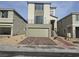 Street view of a modern two-story home featuring a balcony and a two-car garage and brick driveway at 5748 Avondale Rise Way, Las Vegas, NV 89141