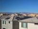 Rooftop view with solar panels and mountain views in the distance under a clear blue sky at 5748 Avondale Rise Way, Las Vegas, NV 89141