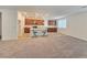 Bright and airy kitchen with wood cabinetry, modern appliances, and a spacious island with seating at 5748 Avondale Rise Way, Las Vegas, NV 89141