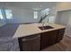 Bright, open floor plan featuring kitchen with a quartz countertop island and stainless steel dishwasher at 5748 Avondale Rise Way, Las Vegas, NV 89141