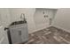 Laundry room features new gray floors, a utility sink, and storage space at 5748 Avondale Rise Way, Las Vegas, NV 89141