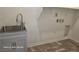 Laundry room features new gray floors, a utility sink, and storage space at 5748 Avondale Rise Way, Las Vegas, NV 89141