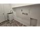 Laundry room features new gray floors, a utility sink, and storage space at 5748 Avondale Rise Way, Las Vegas, NV 89141