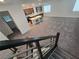 Open-concept living area with kitchen, island seating, and stairs at 5748 Avondale Rise Way, Las Vegas, NV 89141