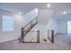 Bright room with modern staircase and railing, large window, and neutral carpet at 5748 Avondale Rise Way, Las Vegas, NV 89141