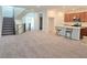 Open-concept living area with staircase, seamlessly blending the kitchen and living space with stylish design at 5748 Avondale Rise Way, Las Vegas, NV 89141