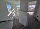 Well-lit staircase with carpet, modern railings, and views of the houses outside at 5748 Avondale Rise Way, Las Vegas, NV 89141
