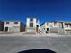 Street view of modern homes with neutral paint, each featuring a two-car garage and contemporary design elements at 5748 Avondale Rise Way, Las Vegas, NV 89141
