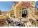 Inviting front entrance featuring a lovely fountain, comfortable seating, and a charming desert-style landscape at 6217 Muirlands Ct, Las Vegas, NV 89130