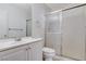This bathroom features a white vanity with a large mirror and a shower with sliding glass doors at 6782 Bonillo Dr, Las Vegas, NV 89103