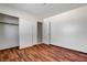 Bedroom with wood floors, closet, and white walls offers ample space at 6782 Bonillo Dr, Las Vegas, NV 89103