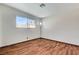 Bright bedroom featuring wood floors and a window offering natural light at 6782 Bonillo Dr, Las Vegas, NV 89103
