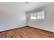 This bedroom features a window for natural light and wood-look floors at 6782 Bonillo Dr, Las Vegas, NV 89103