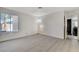 This bedroom offers light wood-look floors, a window for natural light, and an ensuite bathroom at 6782 Bonillo Dr, Las Vegas, NV 89103