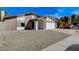 Charming single-story home with a two-car garage and low maintenance desert landscaping at 6782 Bonillo Dr, Las Vegas, NV 89103