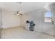 Bright kitchen with tiled floors, a ceiling fan, white appliances, and a door to the backyard at 6782 Bonillo Dr, Las Vegas, NV 89103